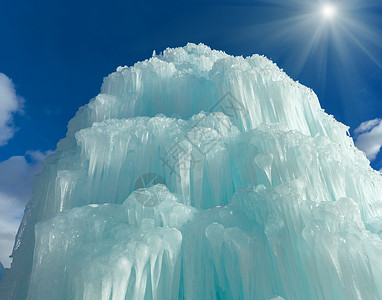 喷泉冰瀑中的冻水在日落的天空背景下图片