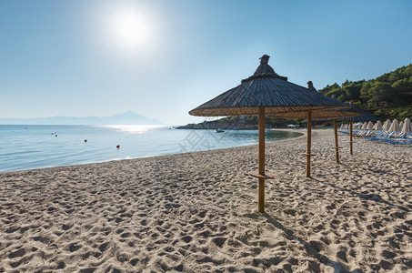 沙滩上带有防晒床和草药遮阳剂希腊查尔基迪图片