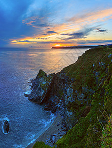欧莱凯素材库大西洋海日落岩石岸线景观靠近卢阿尔卡斯图里亚比凯湾西班牙背景