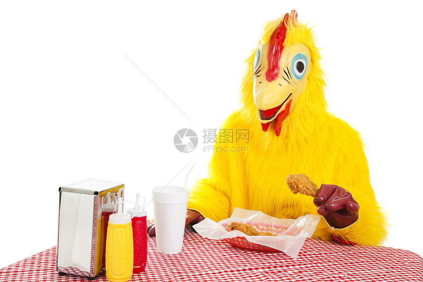穿西装的坐着吃炸鸡晚餐的男人白着被孤立图片