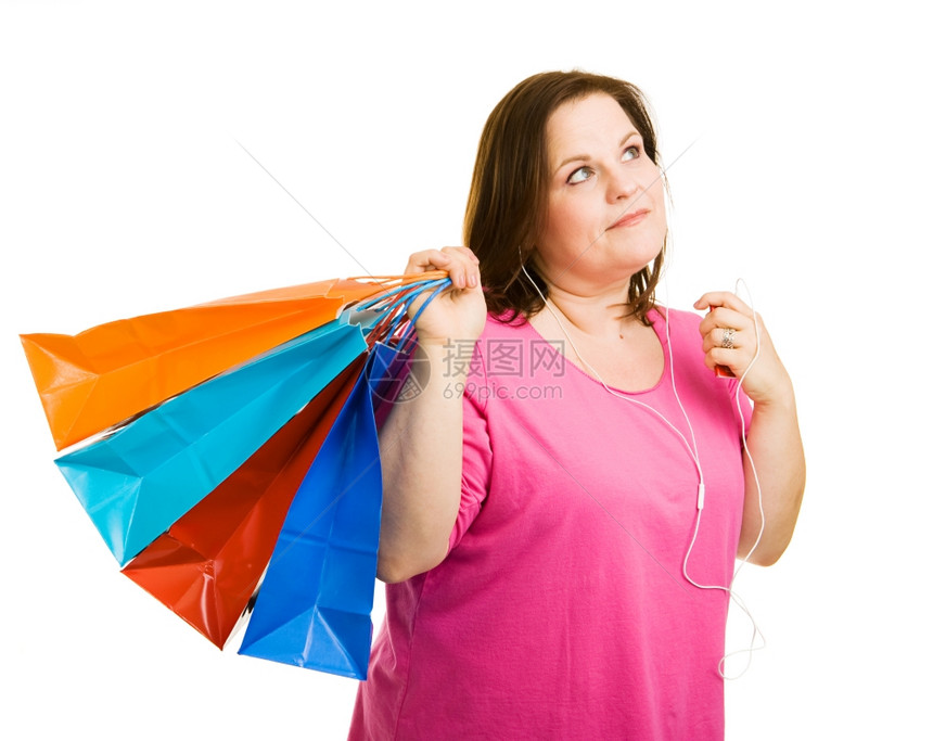 漂亮的超大女子购物和听音乐在她的MP3播放器图片