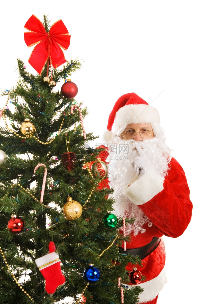 圣诞老人在树周围偷窥让你安静下来图片