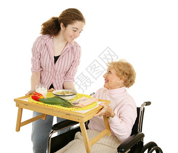 青少年志愿者为一位残疾的老年妇女提供汤孤立在白色上图片