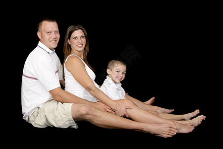 一个美丽的年轻家庭父亲怀孕的母和小男孩满身都是黑色的图片