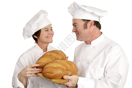 女厨师在检查他烤的面包时和男学生调情孤立的白种人图片