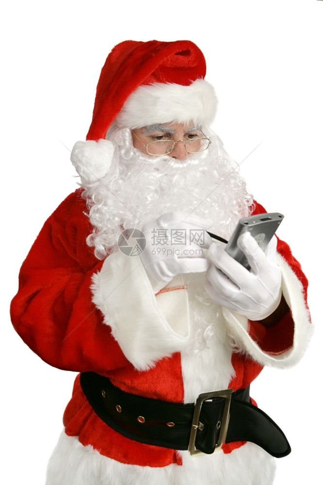 一个更新的圣诞老人在PDA上查他的名单孤立在白色上图片