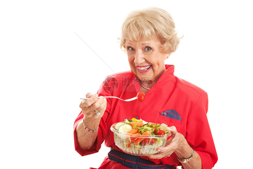 漂亮高龄女子身体健康吃沙拉孤立的白色沙拉图片