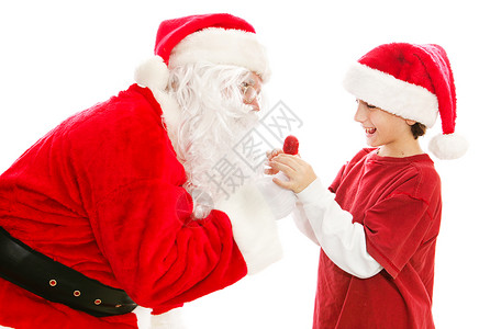 圣诞老人给一个可爱的小男孩一个圣诞棒糖孤立的白人男孩图片