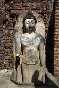 泰国西萨查纳莱摩诃法寺砖墙附近的佛陀图片
