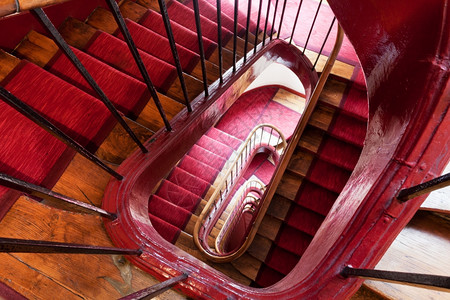 巴黎老房子里红色地毯带的螺旋式步骤图片