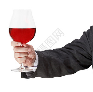 在商人手中用红酒杯和隔绝在白色背景上图片