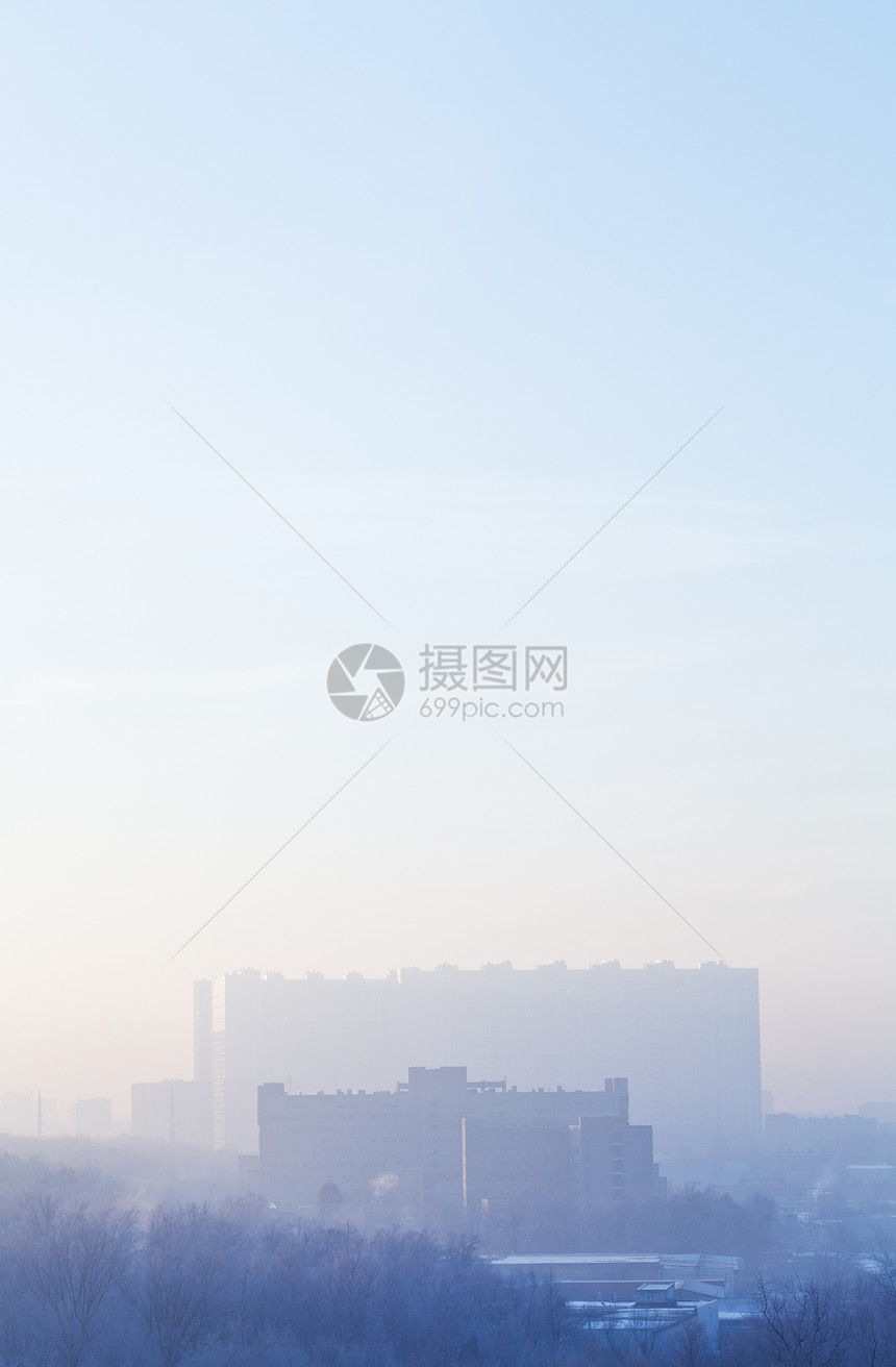 寒冬清晨在城市住宅上空的蓝色日出图片