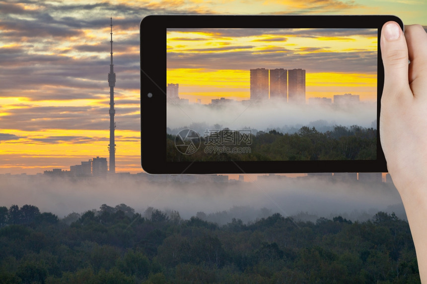 旅游概念者用莫斯科智能手机拍摄秋天城市黄日出和清晨雾的照片图片