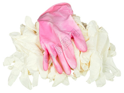 其中1人用粉色保护手套在白背景隔离的一堆新医疗手套上图片