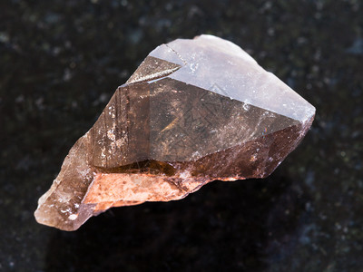 天然矿物岩石标本的大型暗花岗岩底的烟雾石宝晶体背景图片