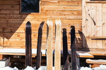 日短之至在俄罗斯摩伦克地区俄罗村庄阳光明媚的冬季日在俄罗斯摩伦克地区在木屋前的宽阔森林滑雪背景