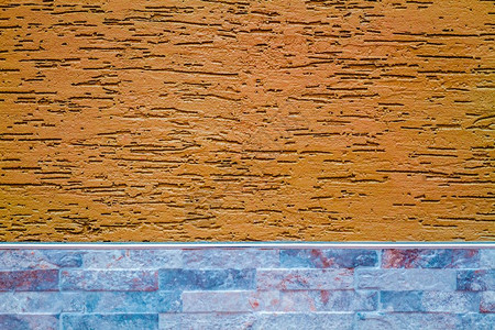 涂有装饰石膏的橙色墙作为质地和背景背景图片