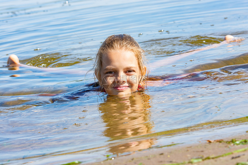 一个十岁的女孩躺在河边水里图片