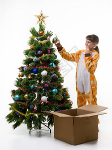 女孩看哪比挂球装饰圣诞树更好图片