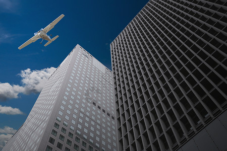 飞机在空中的摩天大楼飞过图片