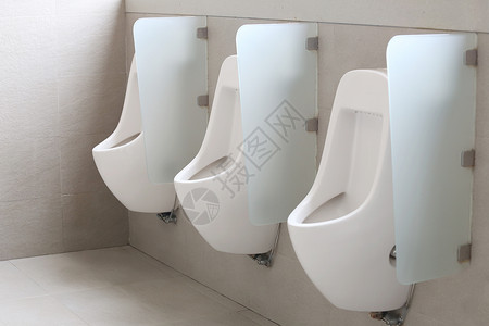 现代男厕所小便池白色陶瓷小便池男在厕所房间背景图片