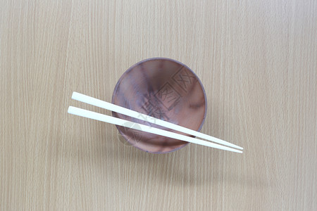 白筷子和碗放在设计概念食物的木材背景顶端视线上背景图片