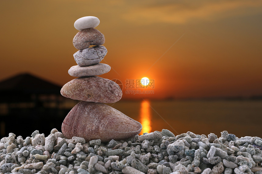 夜晚日落背景的堆石上平衡和概念赞图片