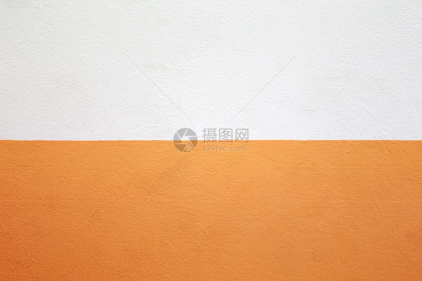 水泥墙漆成橙色和奶油颜的背景图片