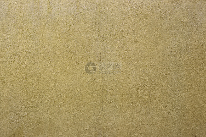 用于设计背景的旧黄色水泥墙表面图片