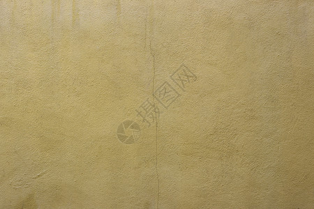 用于设计背景的旧黄色水泥墙表面背景图片