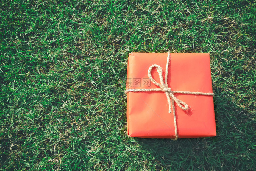圣诞新年情人节或周纪念日绿草坪上的红礼盒图片