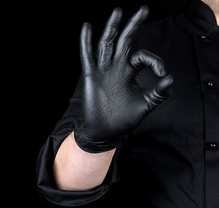 男主厨用黑色乳胶手套和制服的手举着势背景图片