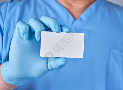 蓝色通用名片穿着蓝色乳胶手套的男医生持有空白纸名片关闭背景