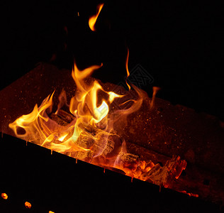 夜火中燃烧的木黑色背景图片
