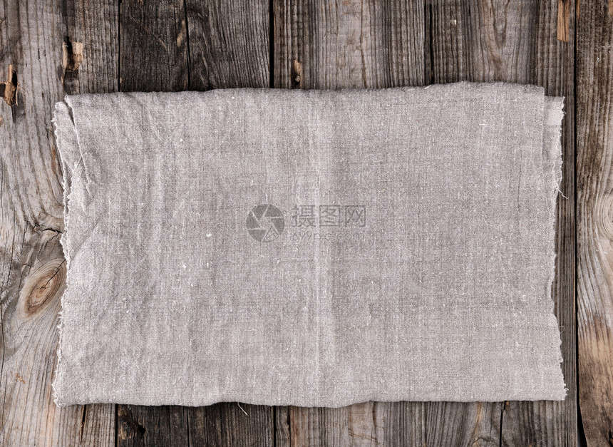 木背景顶视图上的灰色毛巾折叠图片