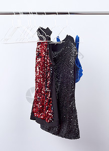黑女布满红色和黑亮片挂在白铁衣架上销售概念图片