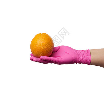 粉色乳胶手套包着圆熟的橙子身体一部分是白安全食品运送的概念图片