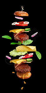 食用汉堡成分切菜芝麻种子包番茄洋葱绿生菜黑底奶酪美味的双芝士汉堡图片