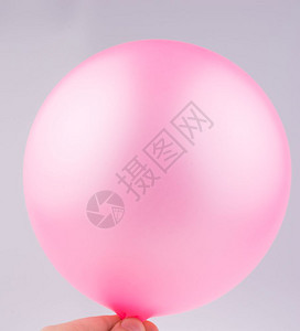 手握着粉红气球白色背景图片