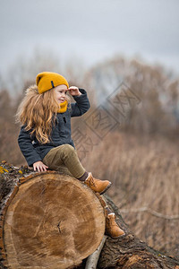 小孩坐在一棵大树的干上一个女孩的肖像坐在一棵巨大的树上974图片