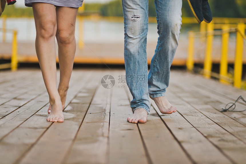 赤脚在自然界中公男和女双脚在654号湖码头的足桥上图片