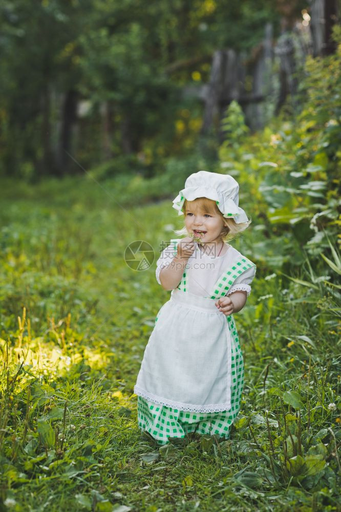 穿着礼服戴帽子的女孩46年在花园散步图片