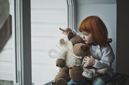 红头发的小女孩和玩具耍图片