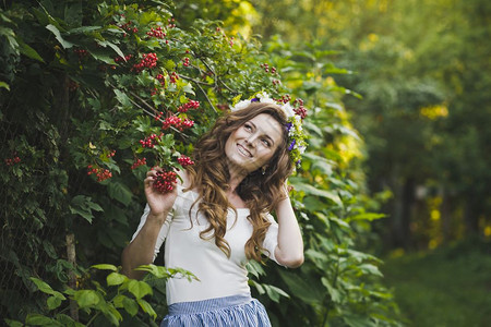 山灰布什附近一个漂亮女孩的肖像花园479有个戴着花圈的女孩肖像图片