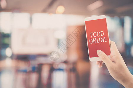 手持电话与食物订单在线餐厅背景模糊订购食物在线商业概念图片