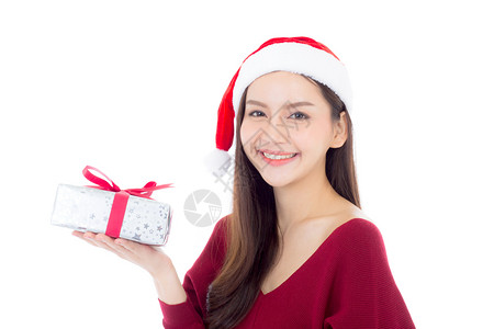 快乐的亚洲女人与微笑持有礼物盒xmas现今女孩与庆祝圣诞节一个假日女孩与买家隔离在白色背景购物与季节概念背景图片