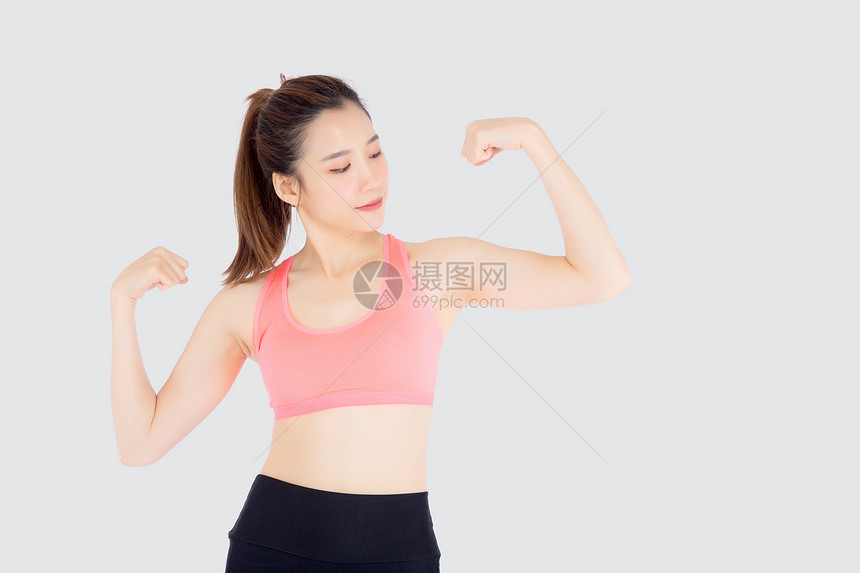 年轻女穿着运动服身强体壮健康女孩展示比塞普斯锻炼和健康图片