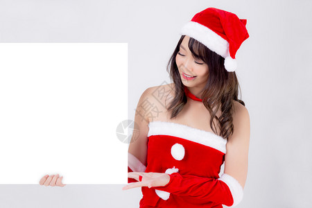美丽的年轻圣诞老人女子在节假期和新年的广告中展示空的标语纸海报图片