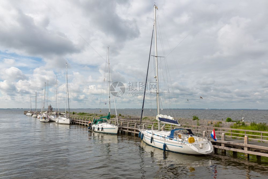 具有历史意义的荷兰乌尔克村港现代游艇停靠在码头图片