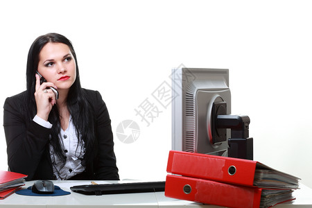坐在办公桌前的讲电话现代商业妇女图片